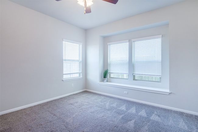 Carpeted empty room with baseboards and ceiling fan | Image 24
