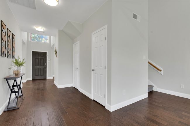 Foyer featuring dark wood-style floors and stairway | Image 4