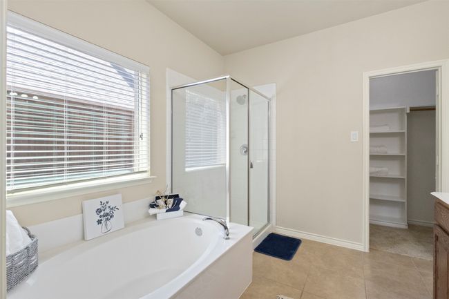 Full bathroom with a shower stall, a garden tub, plenty of natural light, and vanity | Image 15