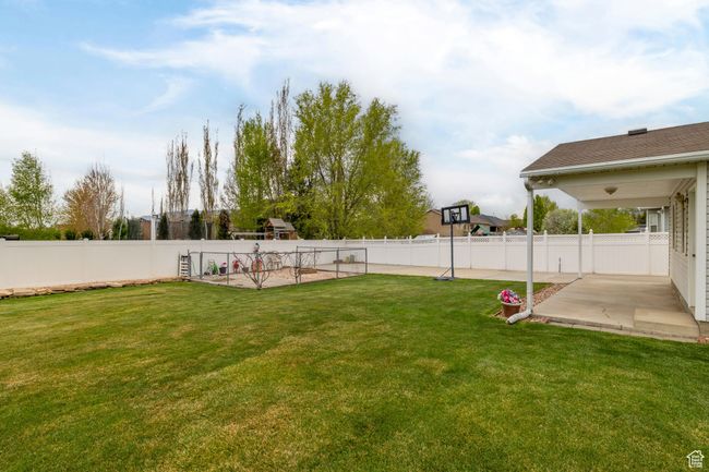 View of yard featuring a patio area and a fenced backyard | Image 48