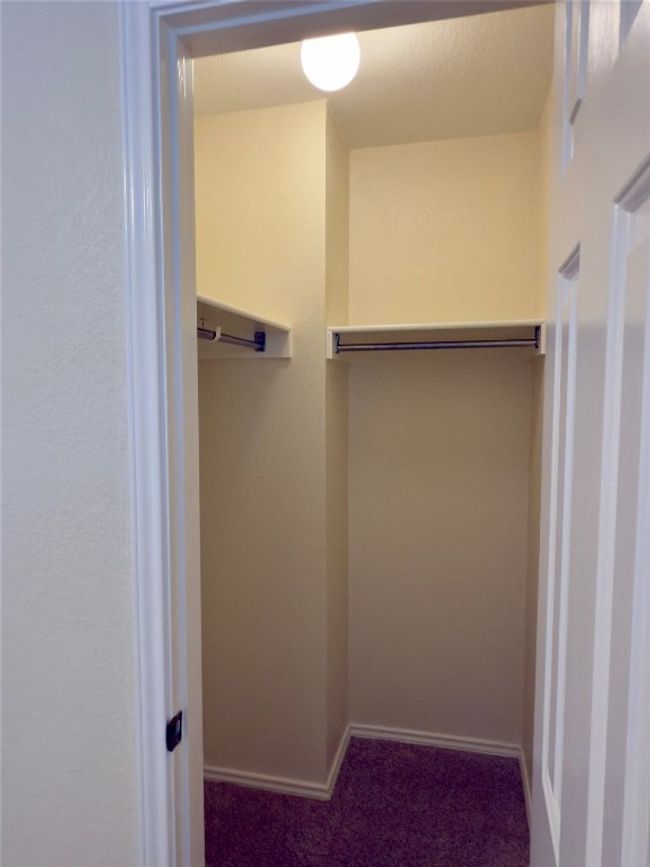 Spacious closet featuring dark carpet | Image 32