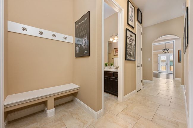 Mudroom with arched walkways and light marble finish flooring | Image 7