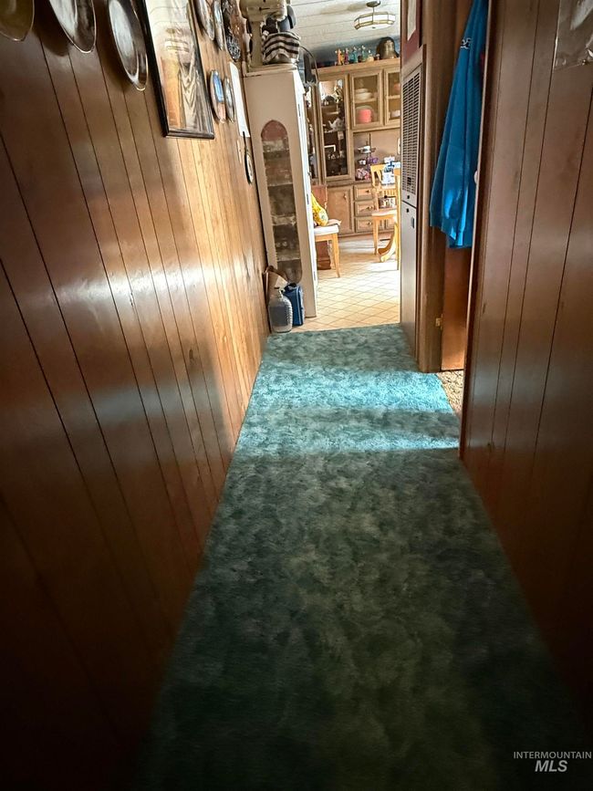 Hall with wood walls and light carpet | Image 18