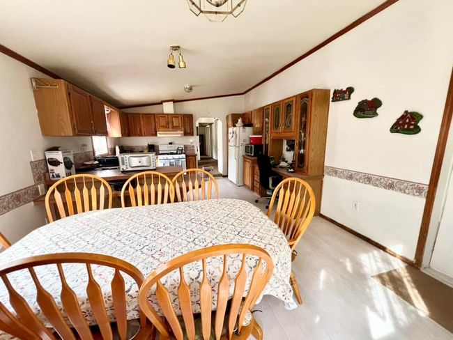 Dining room with vaulted ceiling and crown molding | Image 6