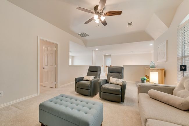 Living room with carpet floors, a ceiling fan, baseboards, and healthy amount of natural light | Image 23