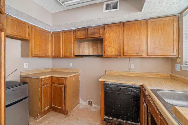 Kitchen featuring dishwasher, brown cabinets, and light countertops | Image 7