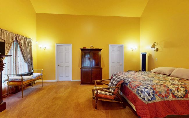 Bedroom with high vaulted ceiling, light carpet, and baseboards | Image 40