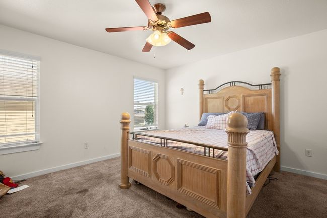 The primary bedroom features neutral tones and abundant natural light, creating a peaceful retreat. | Image 14