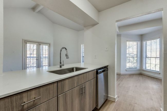 Kitchen featuring light hardwood / wood-style floors, sink, stainless steel dishwasher, and a healthy amount of sunlight | Image 16
