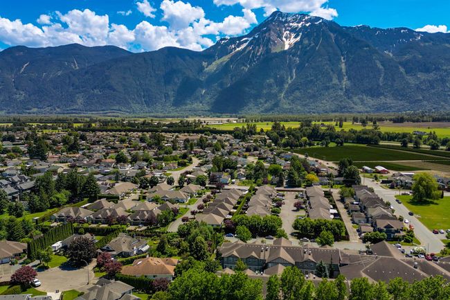 Aerial view of residential area featuring a mountainous background | Image 35