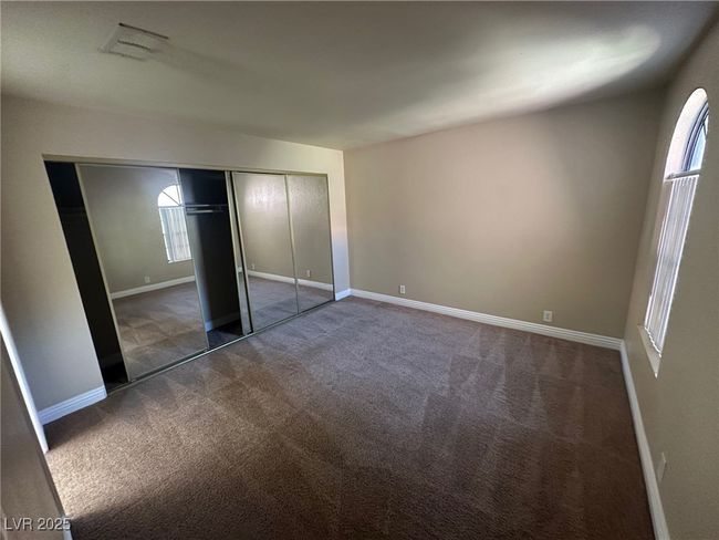 Unfurnished bedroom featuring a closet, multiple windows, carpet floors, and baseboards | Image 17