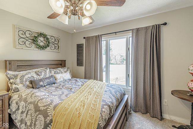 bedroom featuring ceiling fan, carpet flooring, baseboards, and multiple windows | Image 20