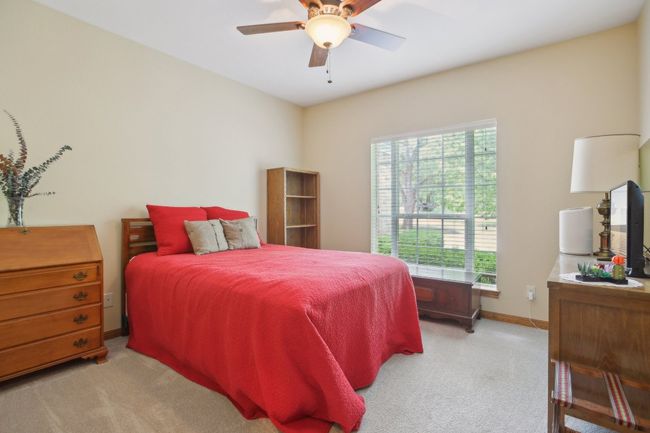 Bedroom with baseboards, ceiling fan, and light carpet | Image 18