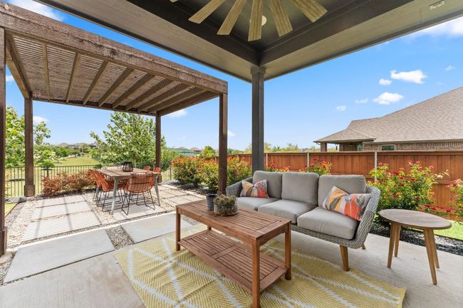 A covered patio provides the perfect space for outdoor dining or relaxing. | Image 17