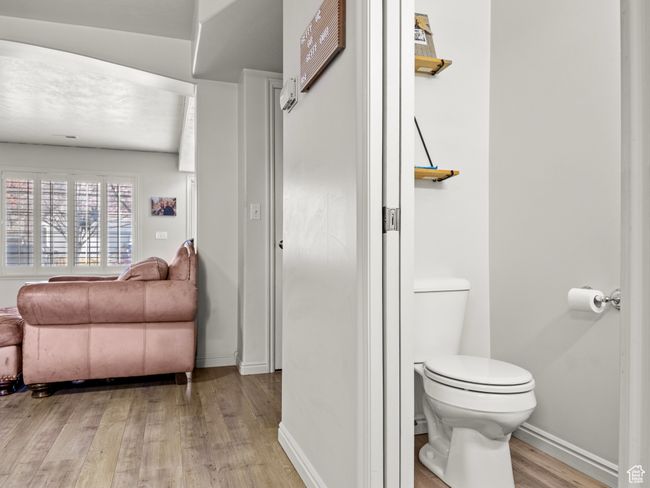 Bathroom with hardwood / wood-style flooring and toilet | Image 11
