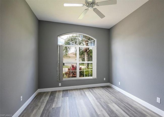 Unfurnished room with hardwood / wood-style flooring, plenty of natural light, and ceiling fan | Image 10