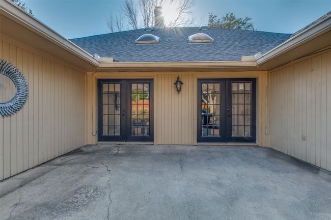 Entrance to property with a patio area, roof with shingles, and french doors | Image 29