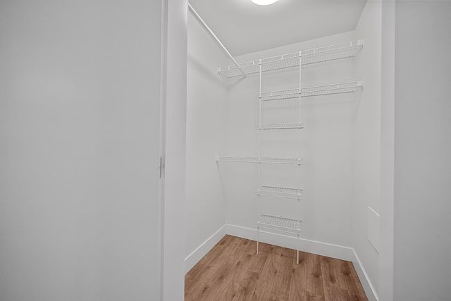Walk in closet featuring light wood finished floors | Image 22