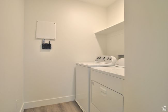 Washroom with washer and dryer and light wood-type flooring | Image 14
