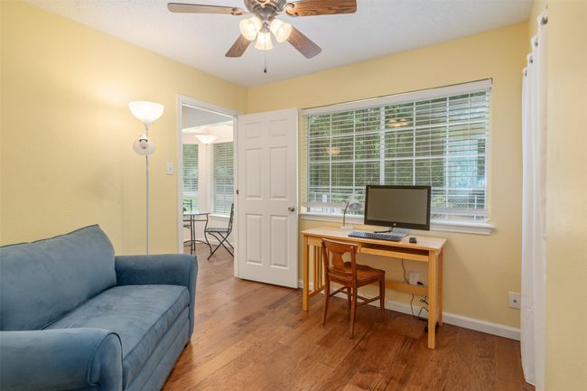 Office featuring wood finished floors, ceiling fan, and plenty of natural light. Add a pullout sofa and you have extra sleeping space or bedroom. | Image 17