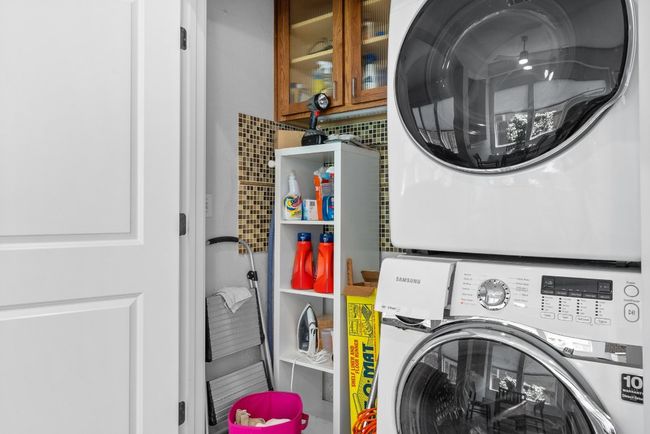 Laundry room with stacked washing maching and dryer and laundry area | Image 28
