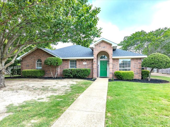 View of front of house with roof with shingles and brick siding | Image 4