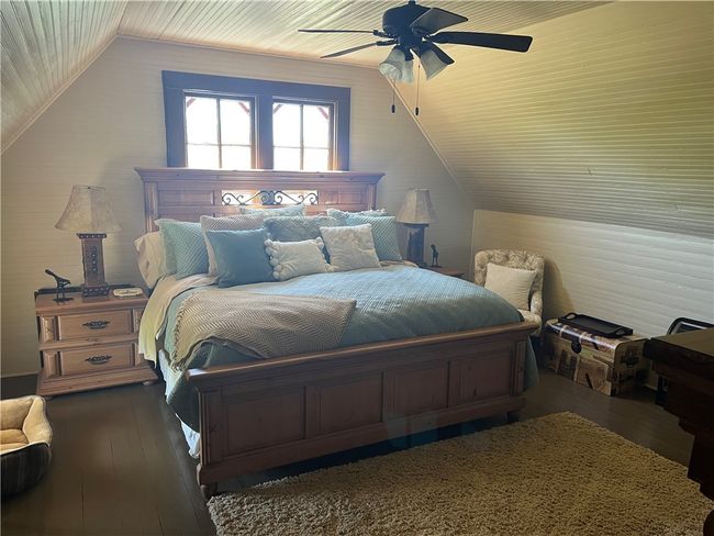 Bedroom with wood-flooring, lofted wood ceiling | Image 29