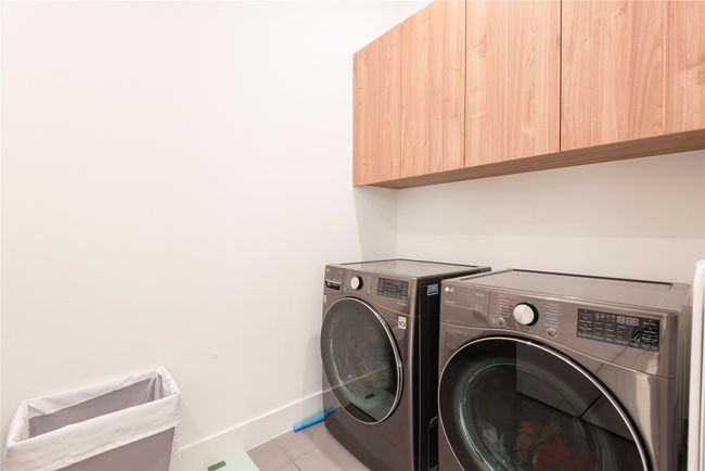 Laundry room with tile floors and sink. | Image 23