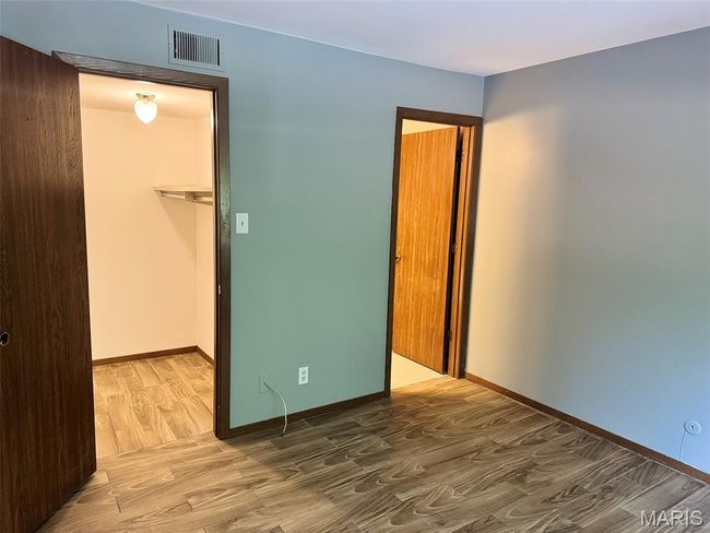 Unfurnished bedroom featuring wood finished floors and a closet | Image 6
