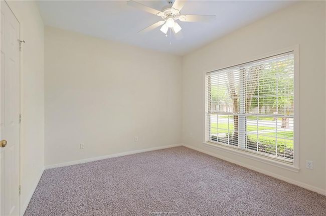 Carpeted empty room with baseboards and ceiling fan | Image 7