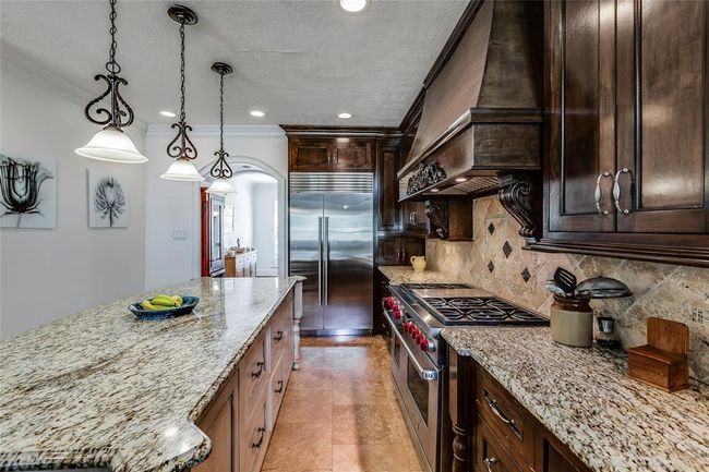 Fantastic custom kitchen full of upgrades including the Wolf Stove with 2 ovens | Image 15