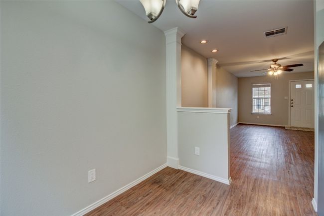 Spare room featuring wood finished floors, a ceiling fan, decorative columns, and recessed lighting | Image 20