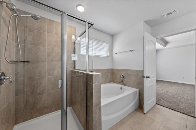 Bathroom with a garden tub, a shower stall, and tile patterned flooring | Image 27
