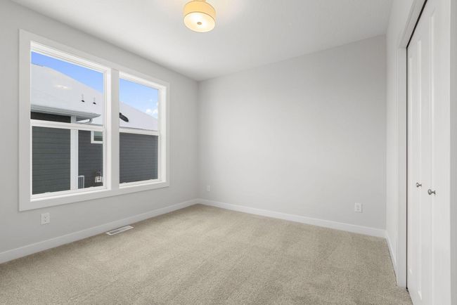 Bright and inviting, this secondary bedroom #3 features a large windows and a cozy atmosphere, creating the ideal space for rest or study. | Image 29