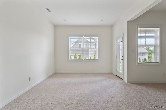 Empty room featuring light carpet and healthy amount of natural light | Image 39