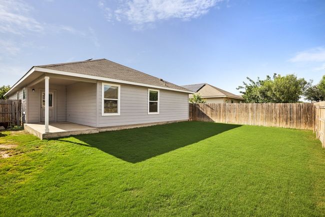 Back of property with a patio, a fenced backyard, and a shingled roof | Image 29
