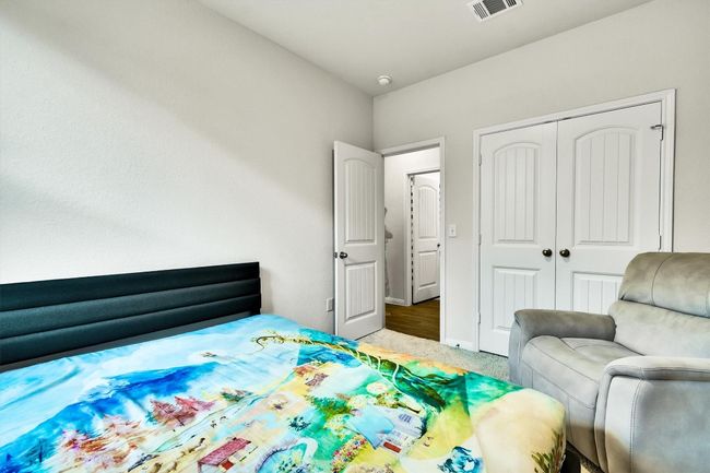 Bedroom with a closet, carpet floors, and baseboards | Image 28