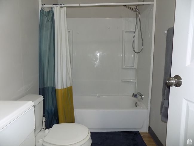 Full bathroom with vanity, toilet, and shower / bathtub combination with curtain | Image 14