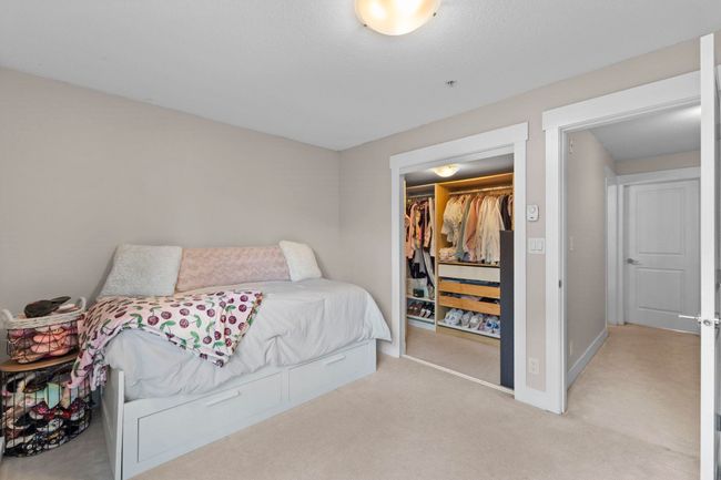 Bedroom with baseboards, a closet, and light colored carpet | Image 19