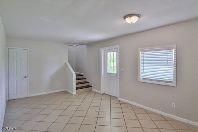 Foyer entrance featuring stairs, baseboards, and light tile patterned flooring | Image 4
