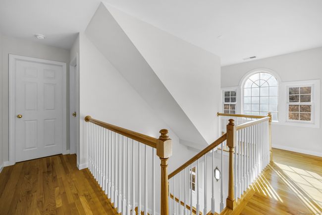 Second floor landing with large Palladium window. NOTE: walk-up attic access around corner of window. | Image 16