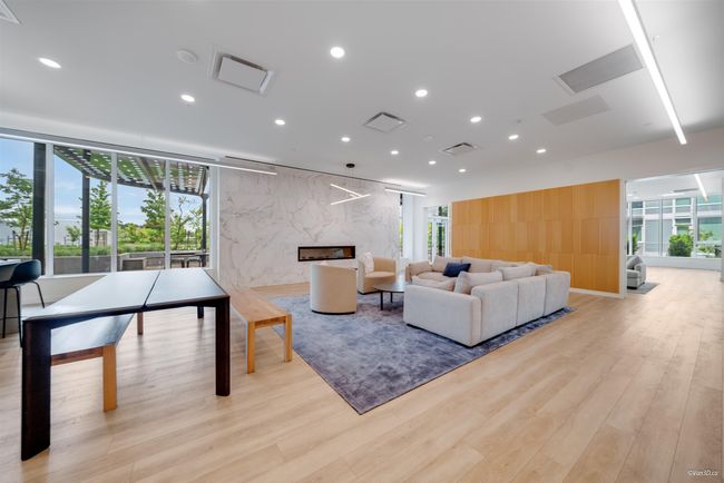 Living area with light wood-type flooring, recessed lighting, and a fireplace | Image 16