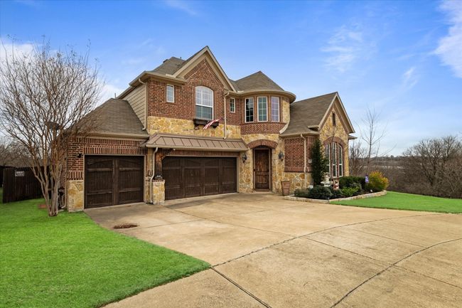 View of front facade with a front yard and a garage | Image 4
