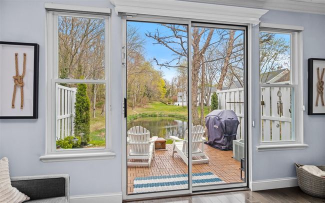 Doorway featuring baseboards, wood finished floors, and a water view | Image 8