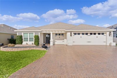 STUNNING 3/3 INDIGO DESIGNER WITH PAVERED BRICK DRIVE AND WALKWAY, PERGOLA ENTRANCE, 2 CAR+ GOLF CART GARAGE LOCATED IN THE VILLAGE OF BRADFORD. | Image 1