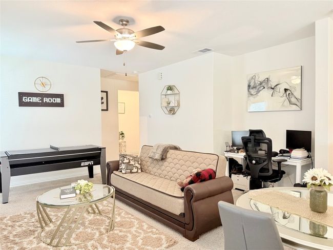 Living area featuring carpet floors, ceiling fan, and a desk | Image 27