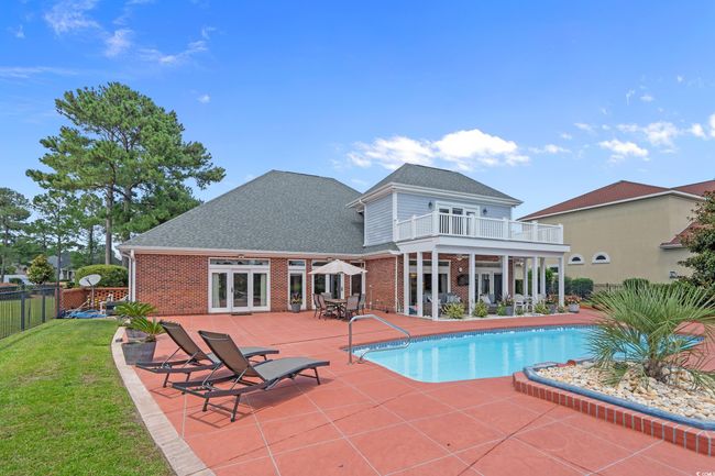 View of swimming pool with french doors and a patio area | Image 17