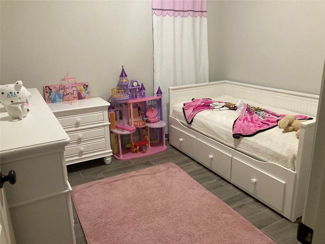 Bedroom with wood finish floors | Image 13