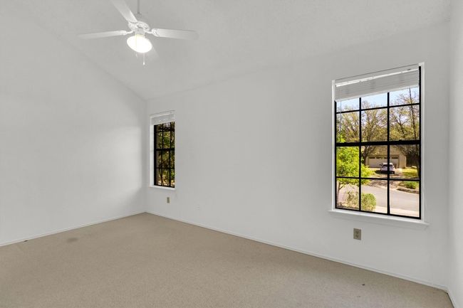 Spare room featuring a ceiling fan, light carpet, and vaulted ceiling | Image 20