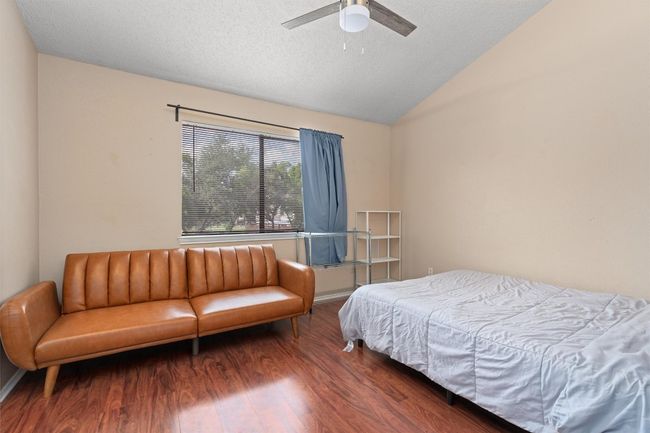Bedroom featuring vaulted ceiling, wood finished floors, and a ceiling fan | Image 15